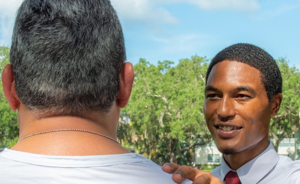 man placing hand on shoulder